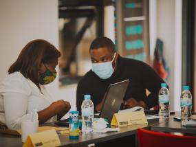 Program Managers work together during a workshop